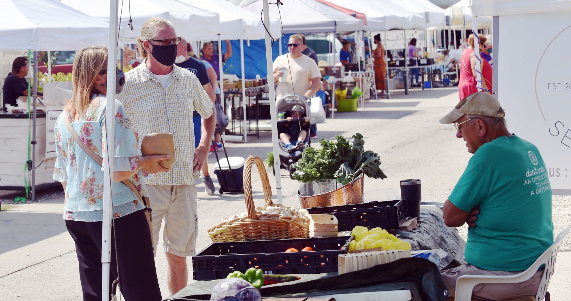 Anthony Hammer makes a produce sale at Milaeger's farmers market on Sunday